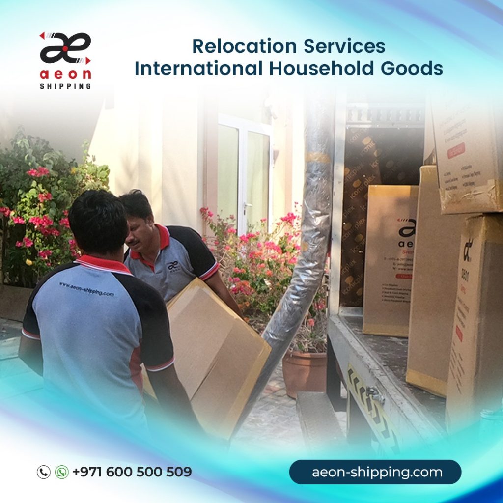 Two men wearing Aeon Shipping uniforms are shown loading or unloading large cardboard boxes from a moving truck. The image is a promotional graphic for international relocation services and includes the Aeon Shipping logo, contact number (+971 600 500 509), and website (aeon-shipping.com). The text on the image reads, "Relocation Services: International Household Goods.